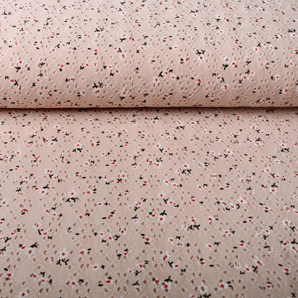 Poederroze broderie jersey met opengewerkte structuur en kleine bloemenprint