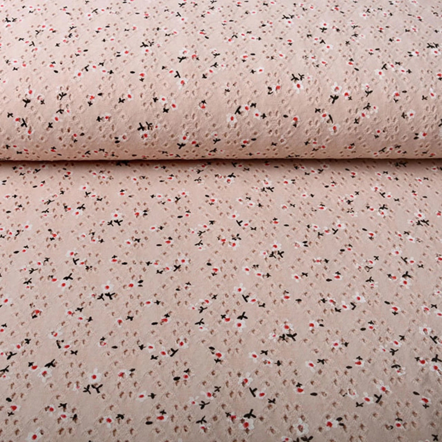 Poederroze broderie jersey met opengewerkte structuur en kleine bloemenprint