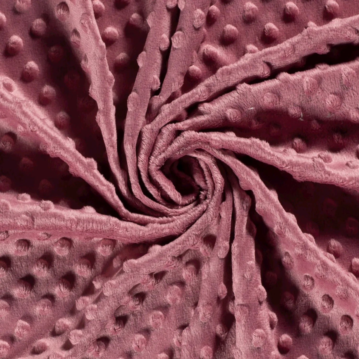 Gedrapeerde oudroze minky fleece met zachte stippenstructuur